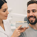 Dentist making color and shape selection with patient for laminate veneers