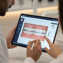 Dentist showing a patient the digital smile design for laminate veneers